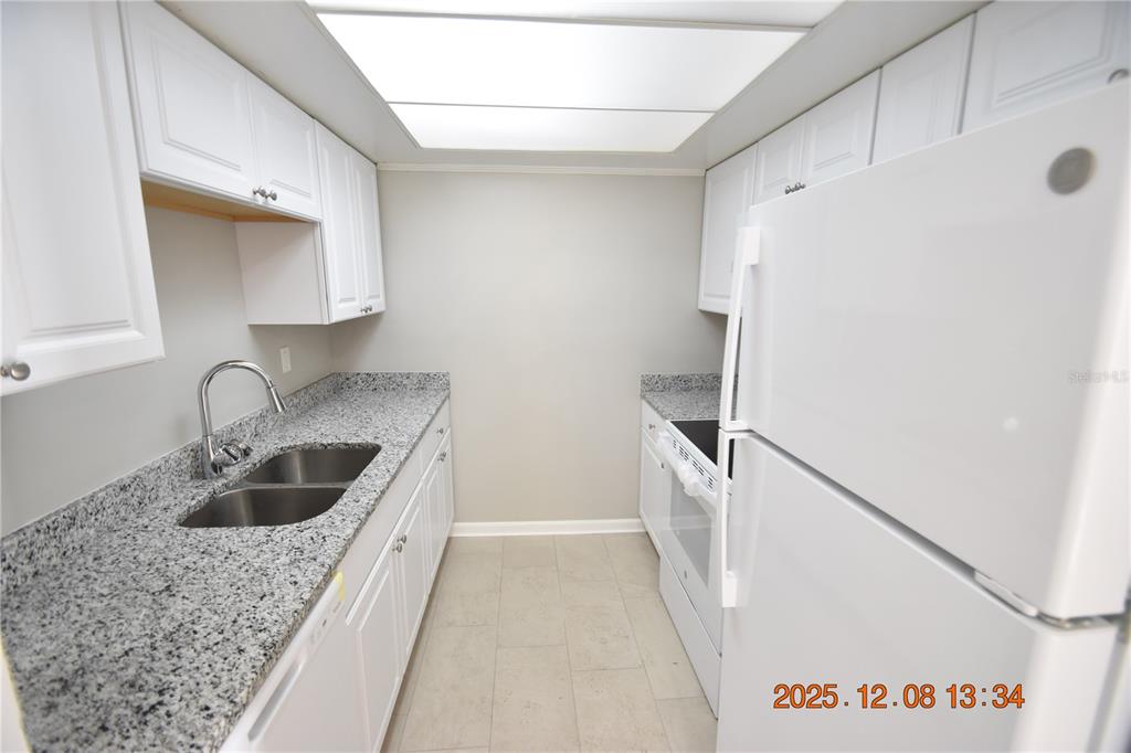 705 2nd Avenue Northwest, Unit B Ruskin, FL 33570 - Photo 20 of 29 a kitchen with a sink a stove and refrigerator