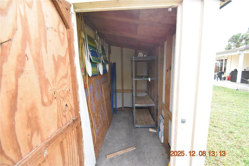 705 2nd Avenue Northwest, Unit B Ruskin, FL 33570 - Photo 27 of 29 a view of a hallway with wooden shelves