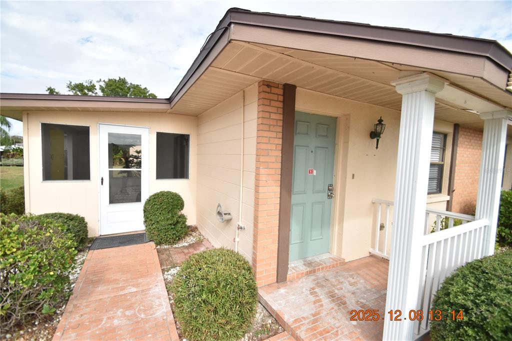 705 2nd Avenue Northwest, Unit B Ruskin, FL 33570 - Photo 28 of 29 a front view of a house with glass windows and table