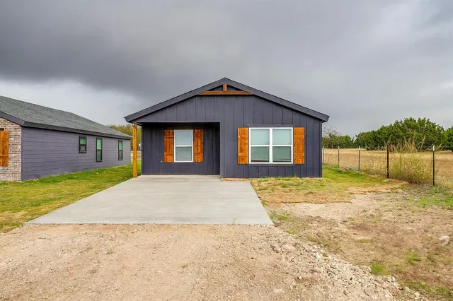 a view of a house with a yard and garage