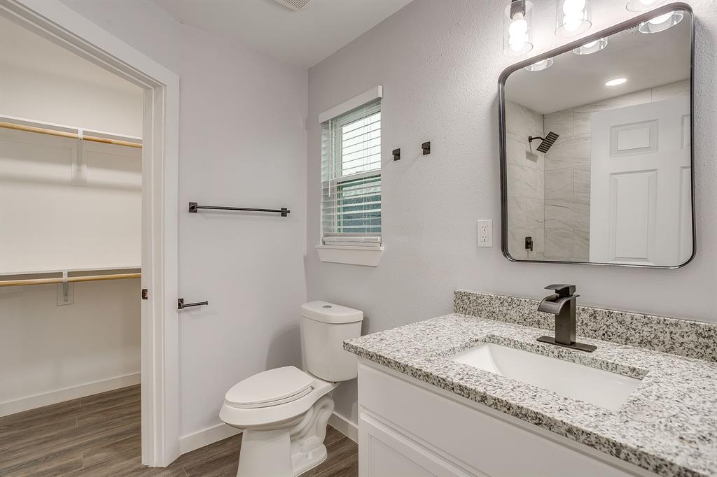 122 Kentucky Street Walnut Springs, TX 76690 - Photo 11 of 18 a bathroom with a granite countertop toilet sink and mirror