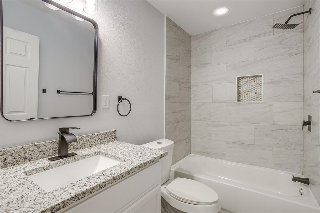 122 Kentucky Street Walnut Springs, TX 76690 - Photo 14 of 18 a bathroom with a granite countertop sink toilet and shower