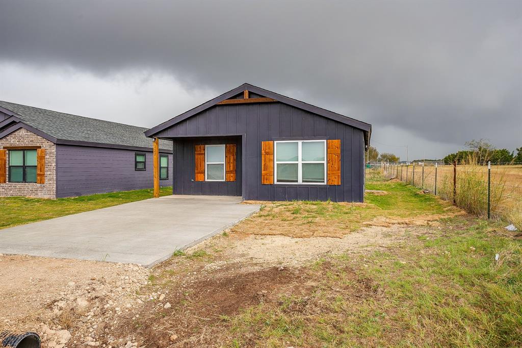 122 Kentucky Street Walnut Springs, TX 76690 - Photo 2 of 18 a view of a house with a yard