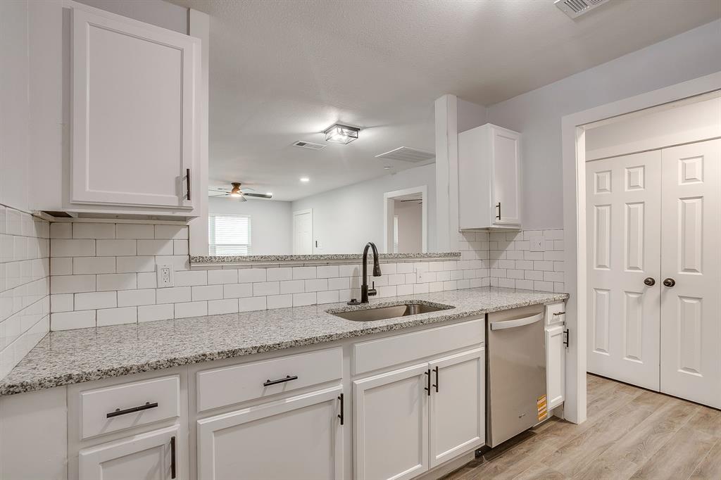 122 Kentucky Street Walnut Springs, TX 76690 - Photo 7 of 18 a kitchen with white cabinets and a sink