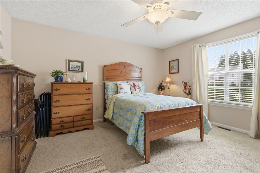 128 Kelly Lane Easley, SC 29642 - Photo 16 of 23 A comforting bedroom with warm neutral tones and a well-lit window creates a peaceful personal haven.