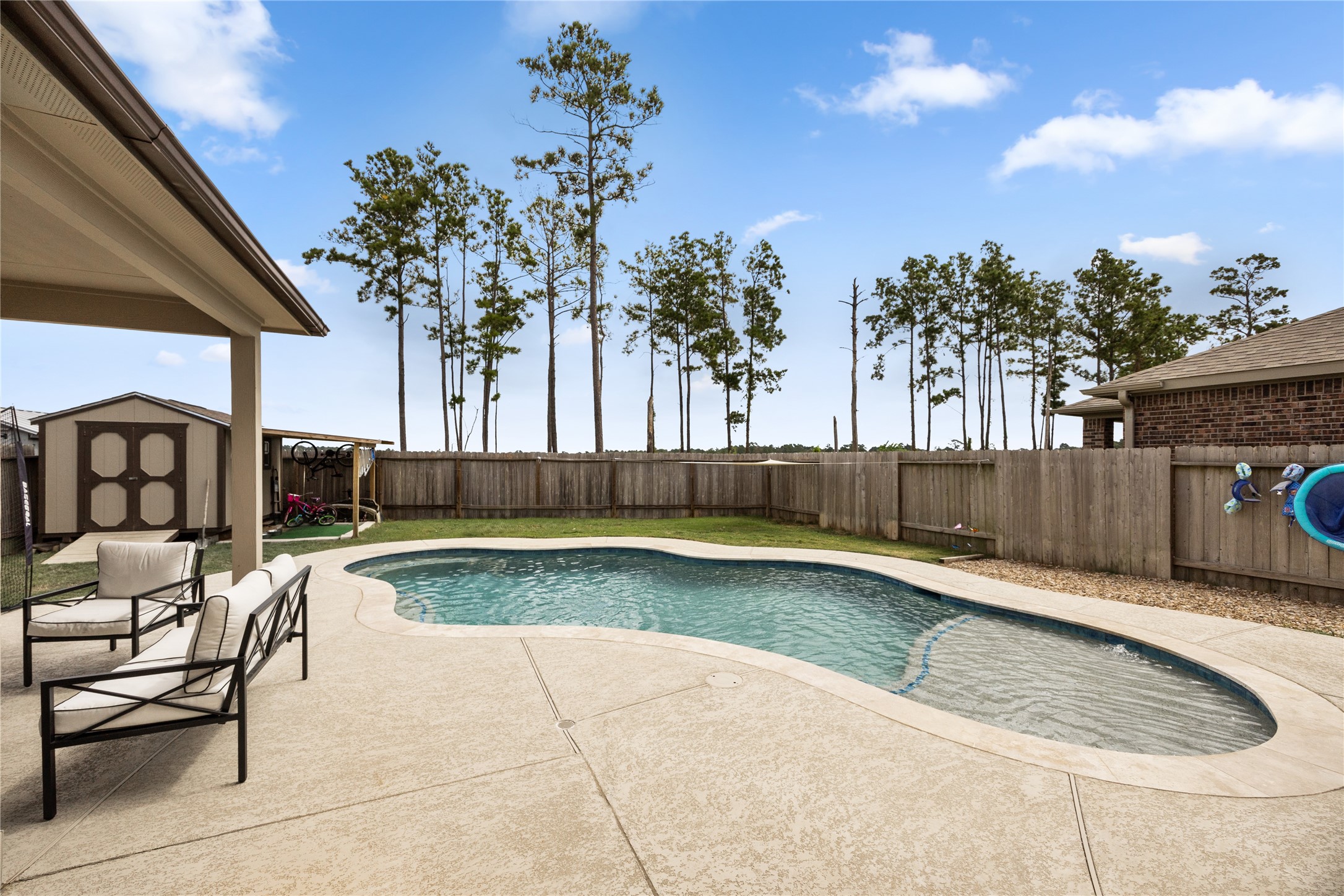 20272 Torrey Pines Lane Cleveland, TX 77327 - Photo 12 of 34 a view of swimming pool with outdoor seating and plants