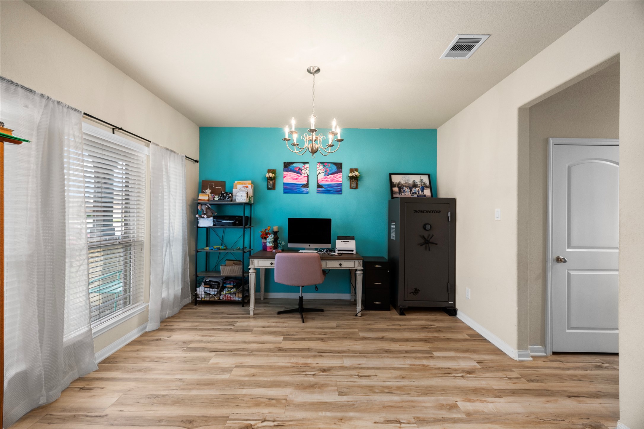 20272 Torrey Pines Lane Cleveland, TX 77327 - Photo 21 of 34 a living room with furniture and a chandelier