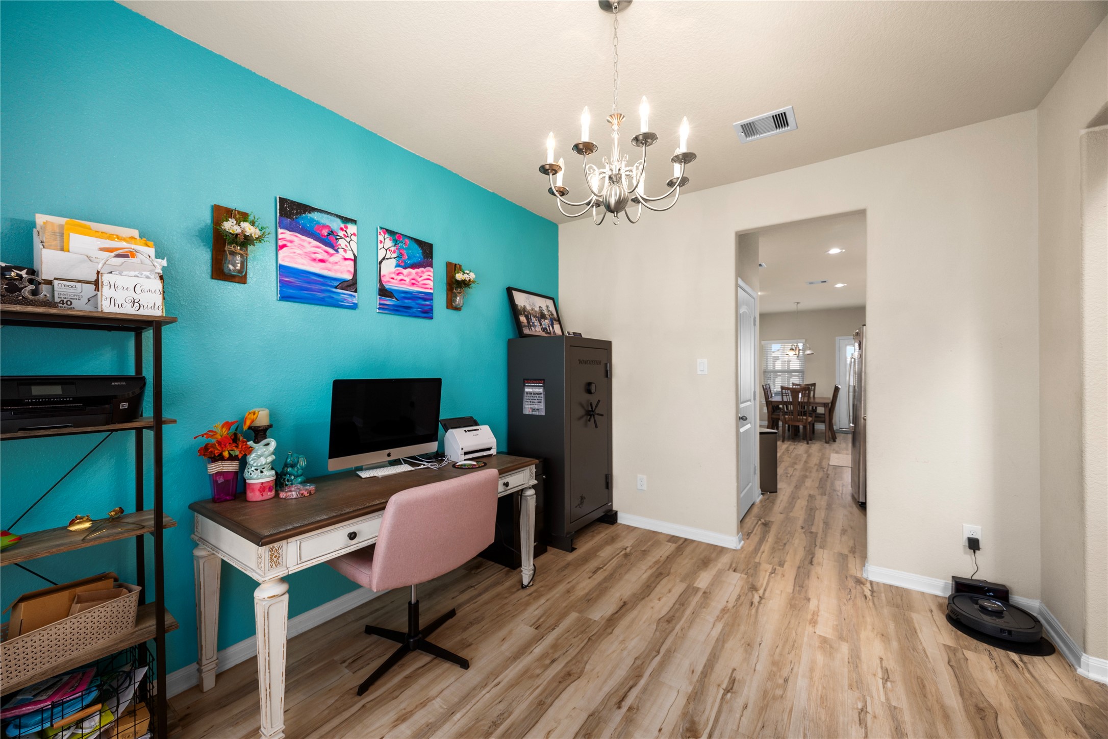 20272 Torrey Pines Lane Cleveland, TX 77327 - Photo 22 of 34 a living room with furniture a fireplace and a chandelier
