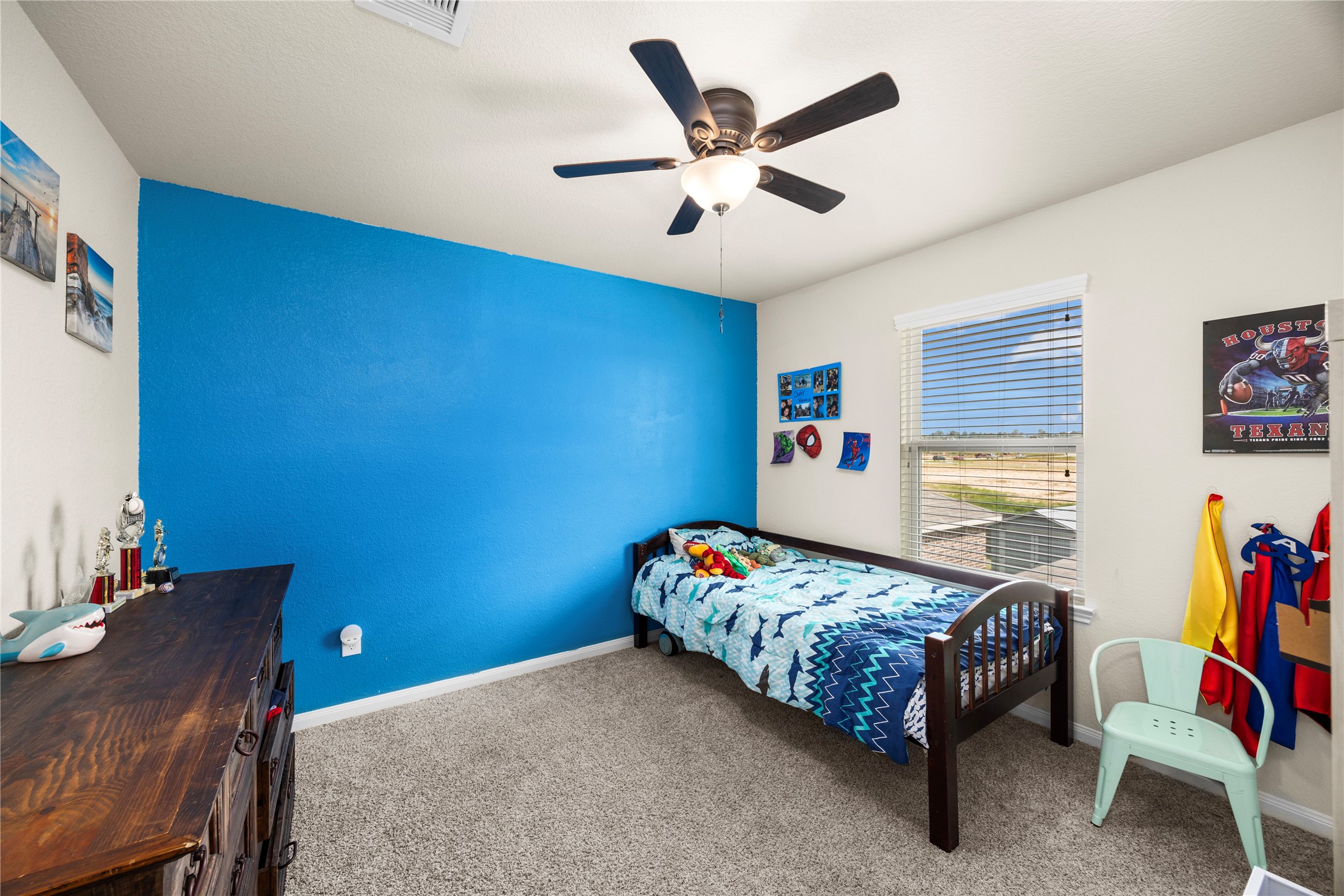 20272 Torrey Pines Lane Cleveland, TX 77327 - Photo 27 of 34 a bedroom with a bed and a chandelier