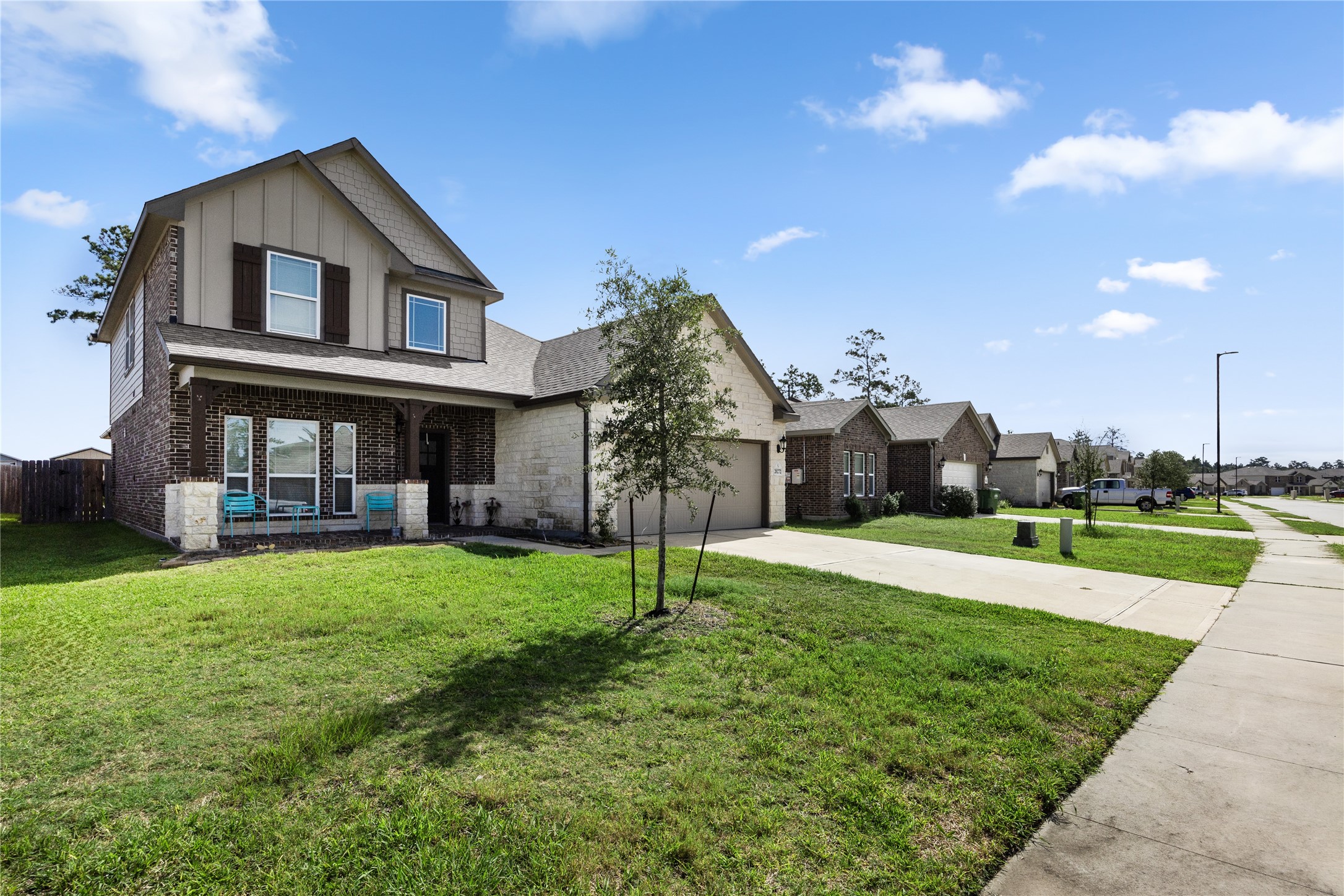 20272 Torrey Pines Lane Cleveland, TX 77327 - Photo 30 of 34 a front view of a house with a yard and garage