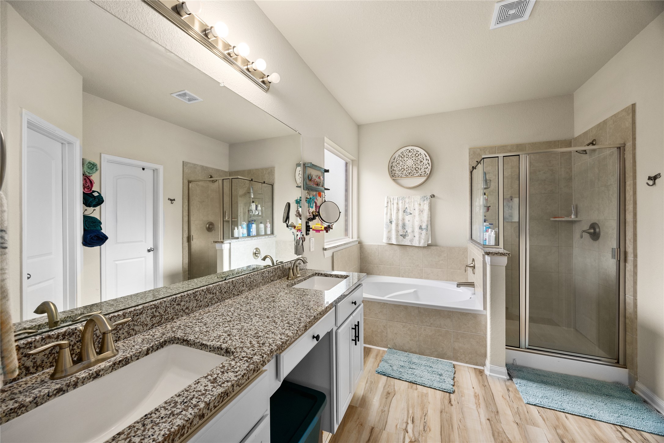 20272 Torrey Pines Lane Cleveland, TX 77327 - Photo 7 of 34 a spacious bathroom with a granite countertop double vanity sink a mirror and shower