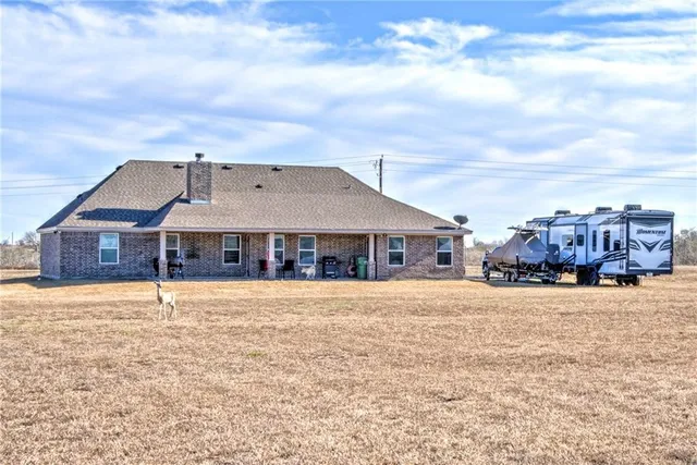 a big house with a big yard and large trees