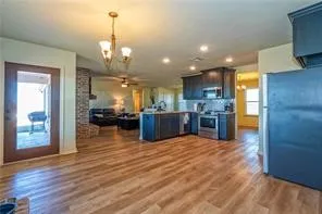 a view of a kitchen with a sink cabinets and wooden floor