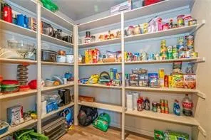 a room with storage and a white refrigerator
