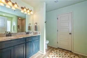 a bathroom with a double vanity sink and a mirror