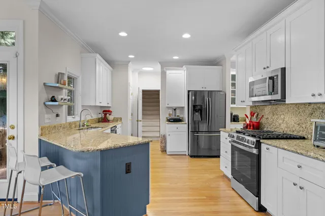 a kitchen with a refrigerator a sink and a stove
