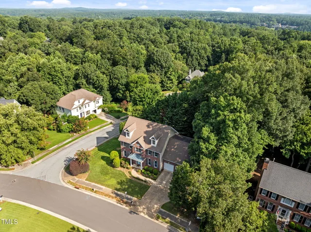 a view of a house with a yard and garden