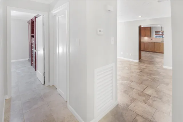 an empty room with closet and windows