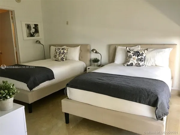 a bedroom with bed and window