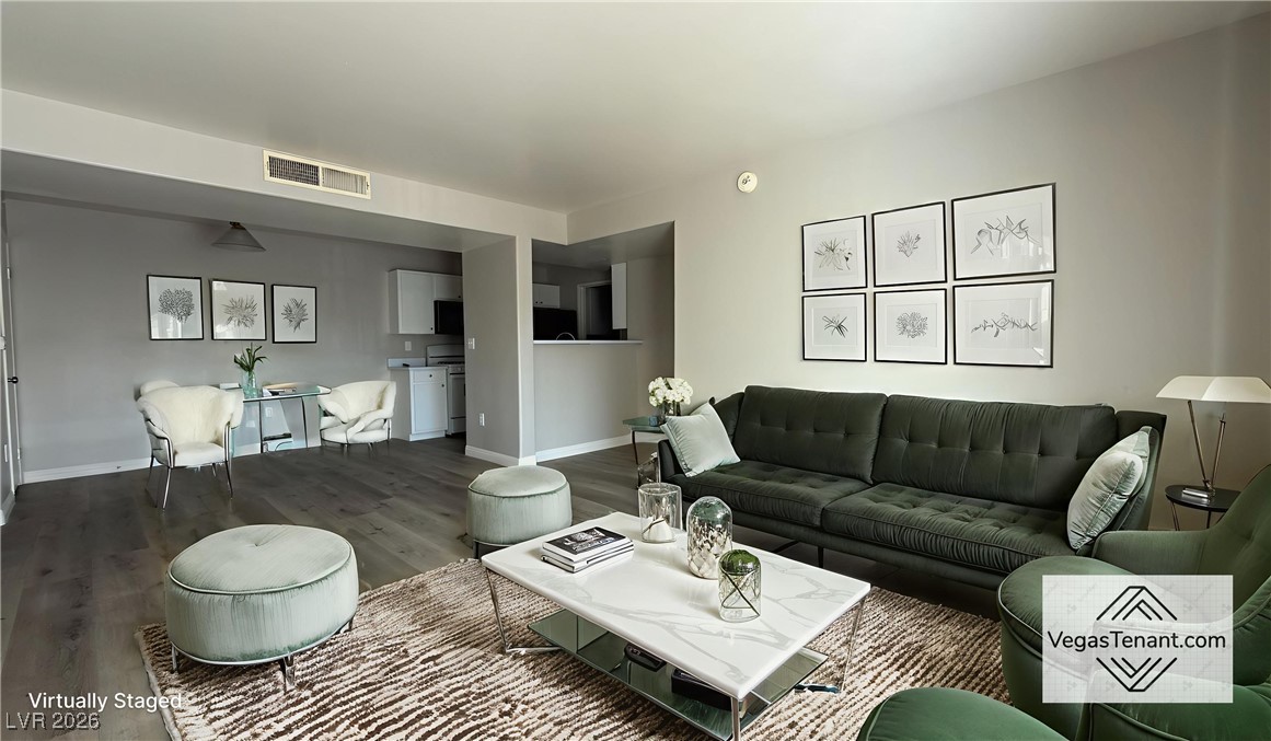 Living area with wood finished floors and baseboards