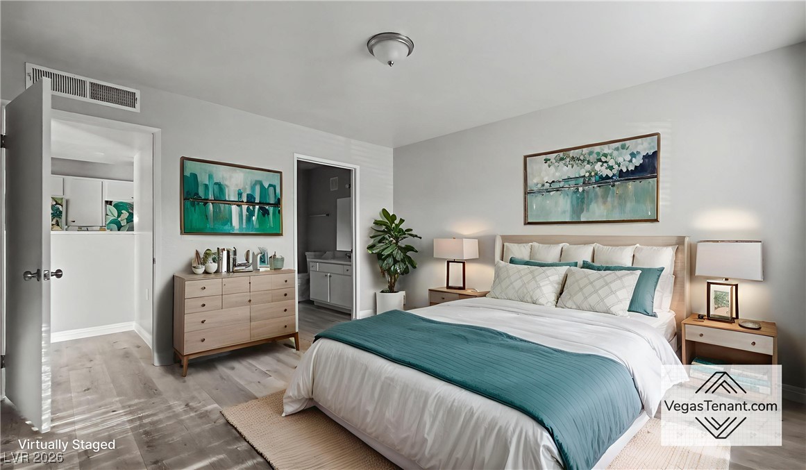 7885 West Flamingo Road, Unit 1148 Las Vegas, NV 89147 - Photo 2 of 9 Bedroom featuring wood finished floors and ensuite bathroom