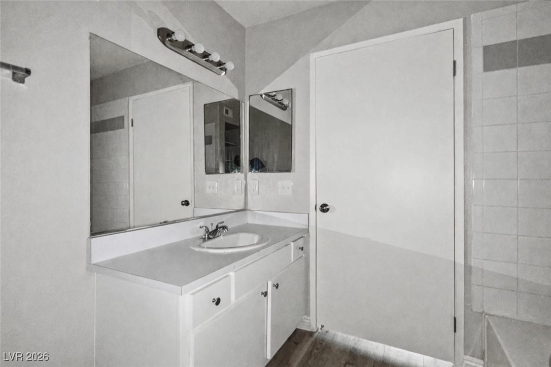 7885 West Flamingo Road, Unit 1148 Las Vegas, NV 89147 - Photo 3 of 9 Bathroom with vanity and dark wood-style floors