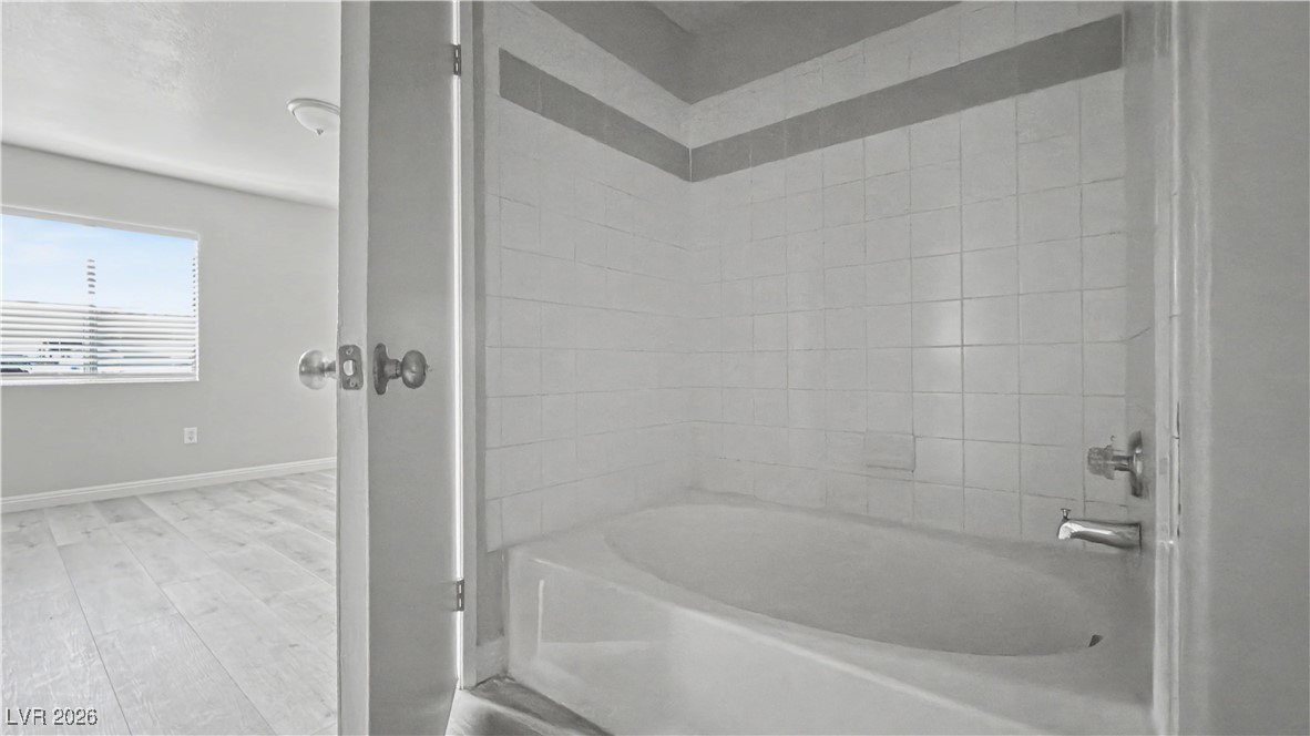 7885 West Flamingo Road, Unit 1148 Las Vegas, NV 89147 - Photo 4 of 9 Bathroom featuring shower combination and wood finished floors