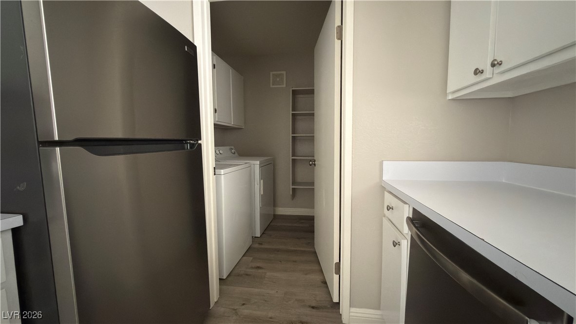 7885 West Flamingo Road, Unit 1148 Las Vegas, NV 89147 - Photo 6 of 9 Laundry area featuring washing machine and dryer, cabinet space, and dark wood-style flooring