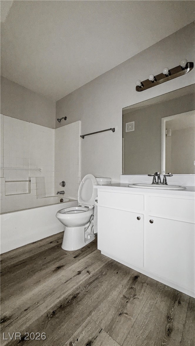 7885 West Flamingo Road, Unit 1148 Las Vegas, NV 89147 - Photo 8 of 9 Bathroom featuring bathing tub / shower combination, dark wood finished floors, and vanity