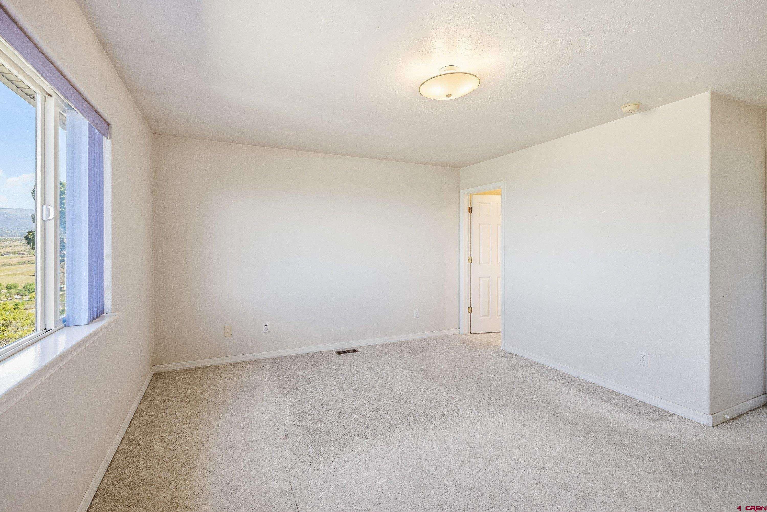 24239 Valley View Circle Cedaredge, CO 81413 - Photo 9 of 18 an empty room with windows