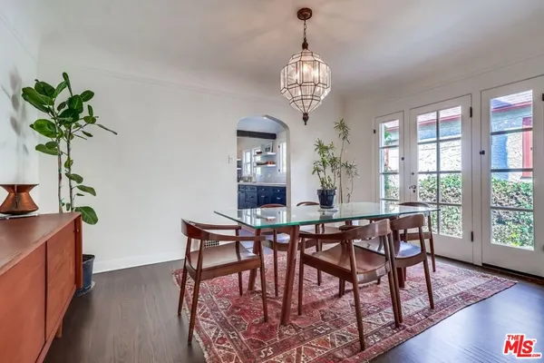 a large kitchen with stainless steel appliances granite countertop a stove a sink dishwasher and cabinets with wooden floor