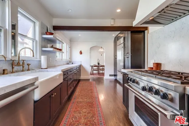 a white toilet sitting next to a bathroom sink and a tub