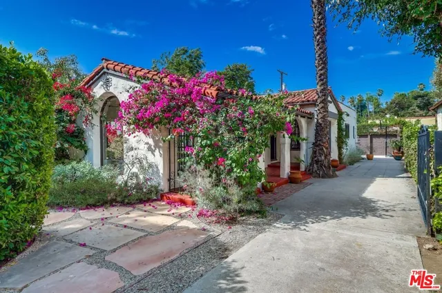 a sign that is sitting in front of flowers