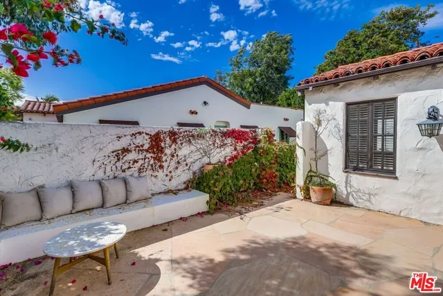 a living room with furniture a fireplace and a chandelier