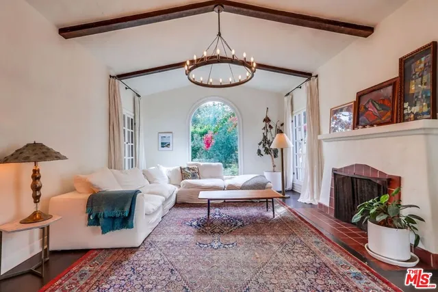 a living room with furniture a rug and a fireplace