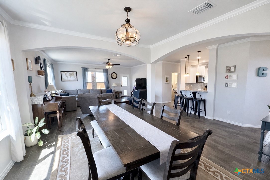 1201 Roma Street Harker Heights, TX 76548 - Photo 13 of 33 a view of a dining room and livingroom with furniture wooden floor a chandelier