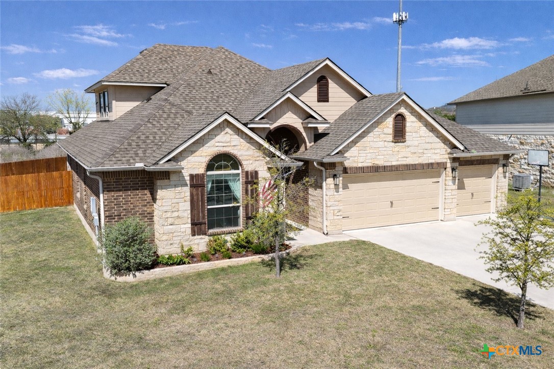 1201 Roma Street Harker Heights, TX 76548 - Photo 2 of 33 a front view of a house with a yard and garage