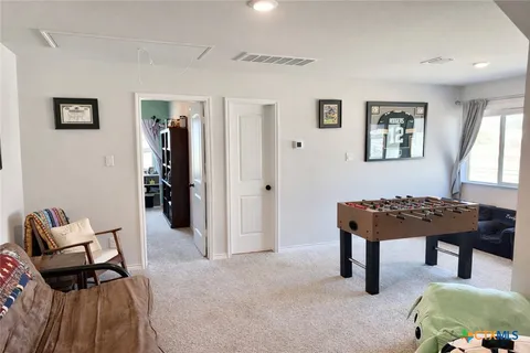 an aerial view of a house with large trees