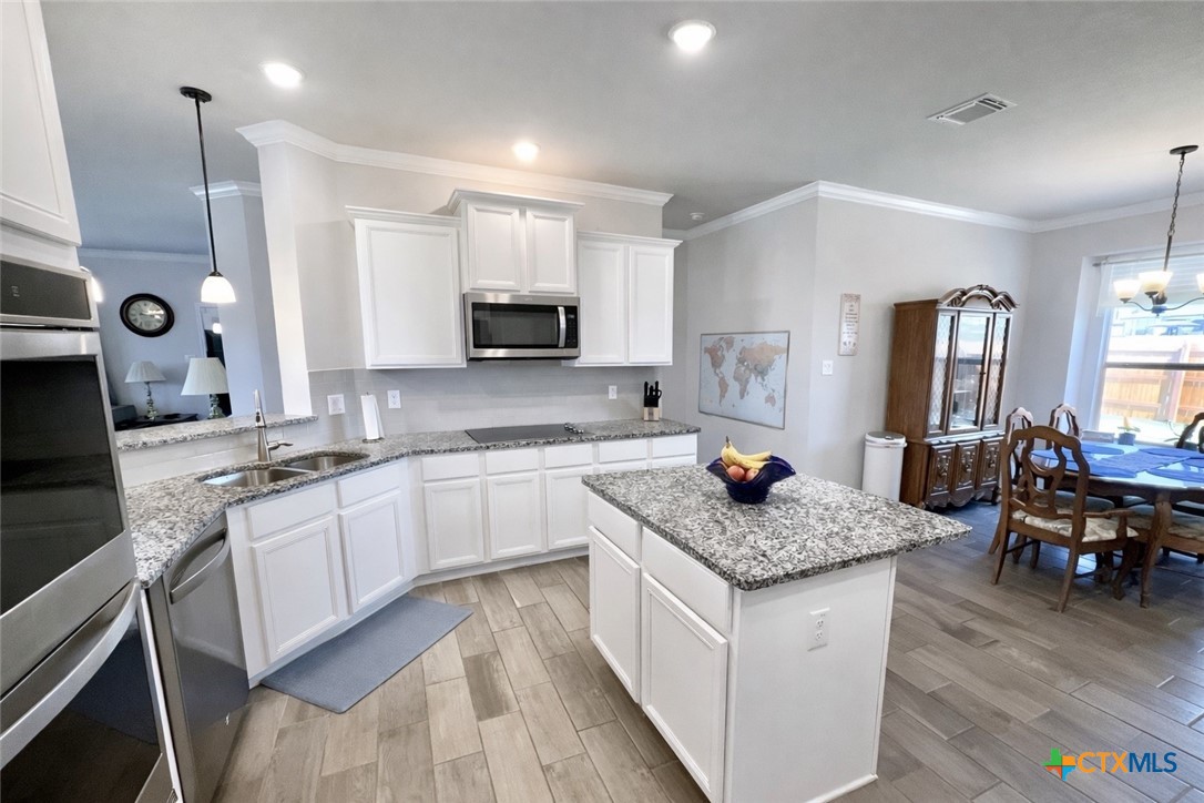 1201 Roma Street Harker Heights, TX 76548 - Photo 7 of 33 a kitchen with stainless steel appliances granite countertop a sink stove and cabinets