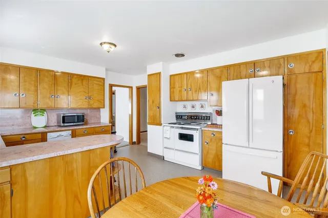 a kitchen with stainless steel appliances a refrigerator sink and stove