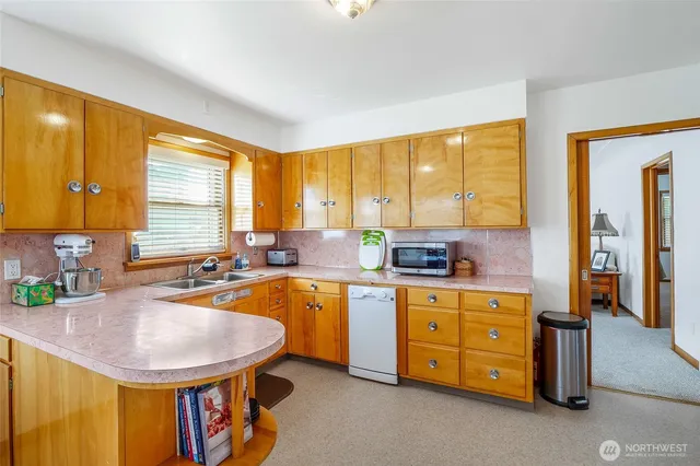 a kitchen with a stove a sink and a refrigerator
