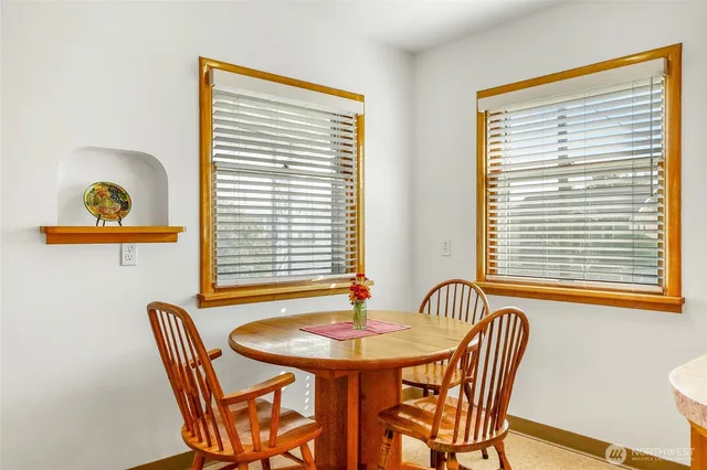 a view of a dining room with furniture and a window