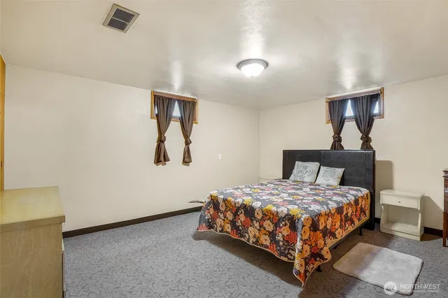 a bedroom with a bed and dresser