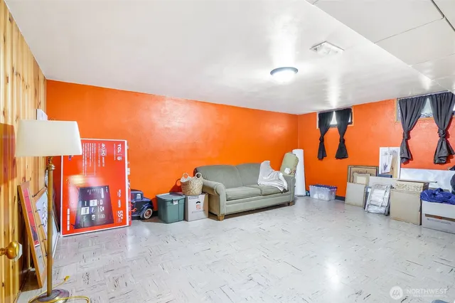 a living room with furniture a lamp and a large window