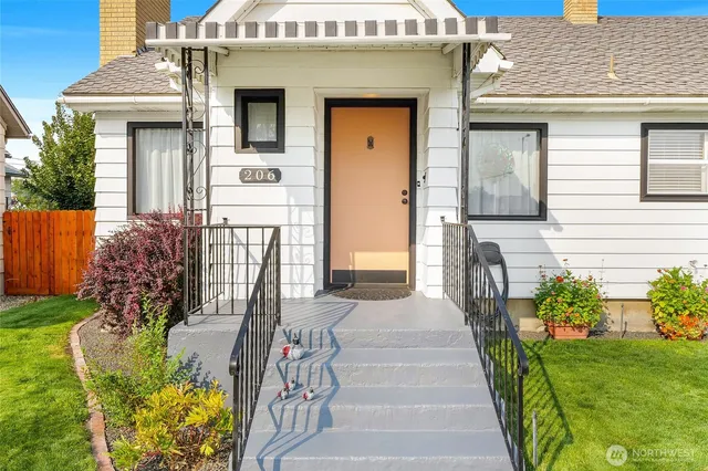 a front view of a house with a garden