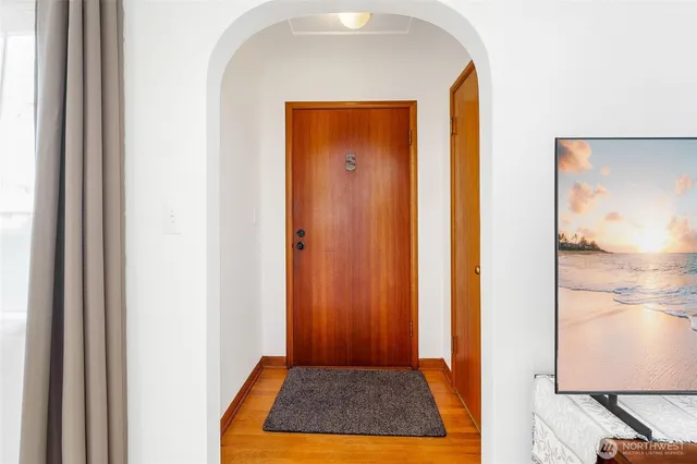 a view of a hallway with wooden floor