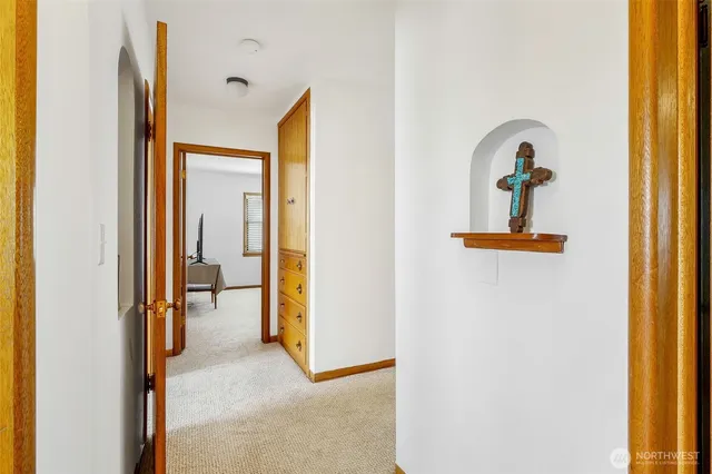 a view of a hallway with mirror and furniture