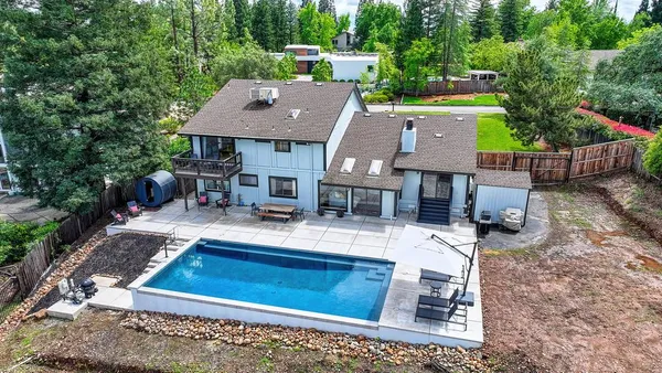 an aerial view of a house with garden space and sitting area