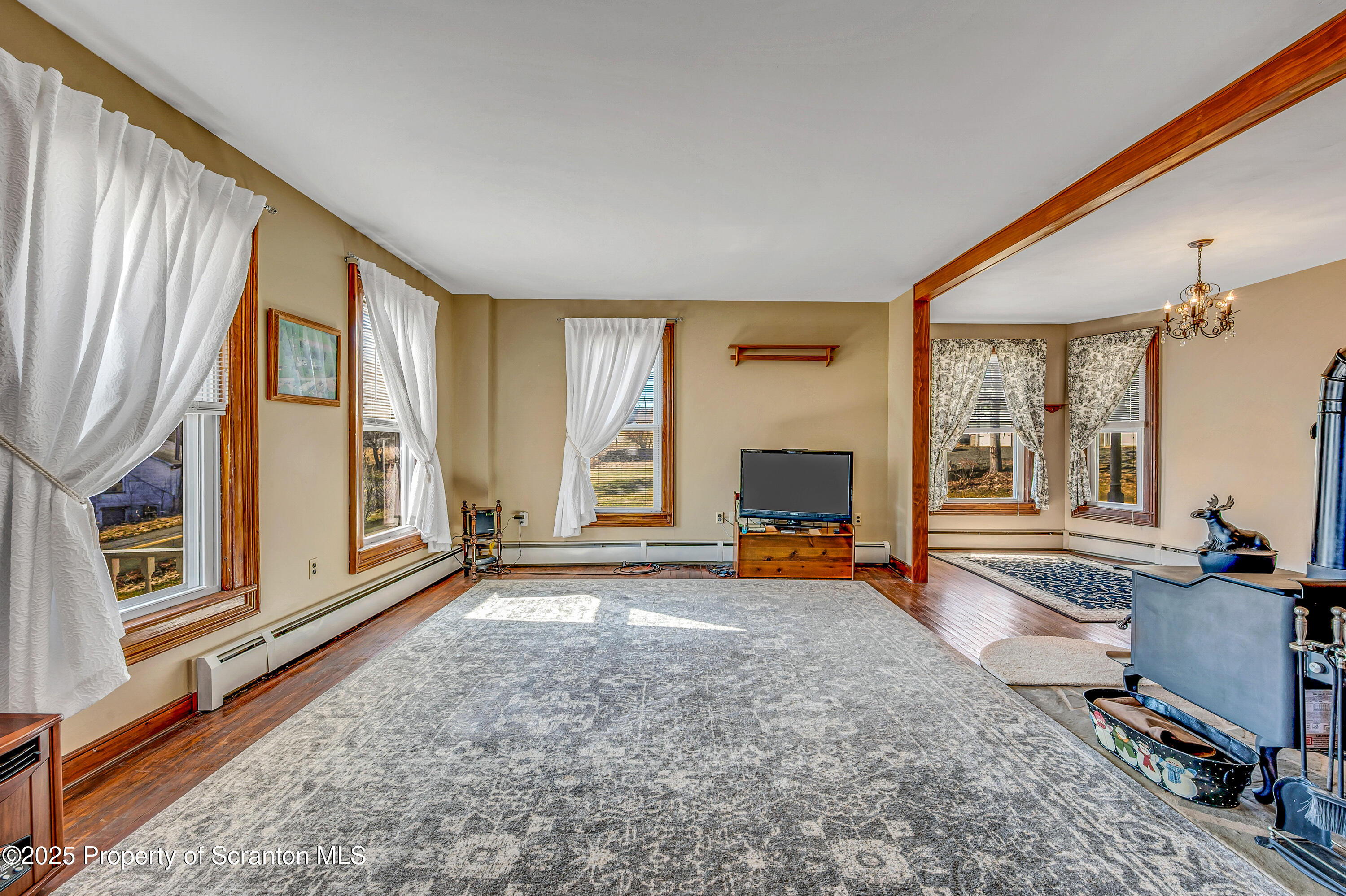 5115 State Rte 3013 Springville, PA 18844 - Photo 27 of 74 a view of a livingroom with furniture a fireplace and windows