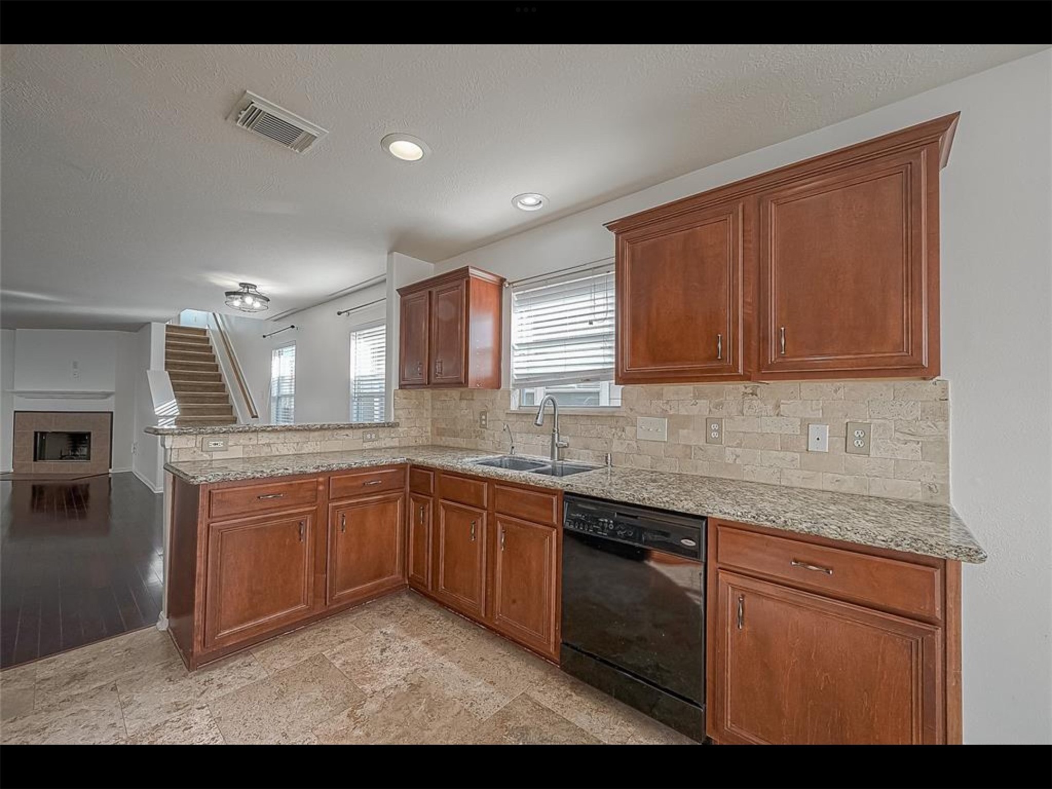 10819 Waterfern Court Houston, TX 77064 - Photo 11 of 37 a kitchen with granite countertop sink stainless steel appliances and cabinets